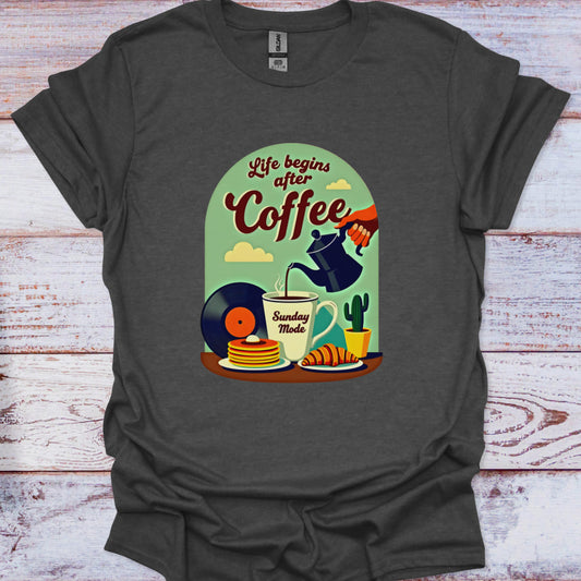 Dark gray t-shirt with a colorful graphic design featuring coffee-themed illustrations on a wooden surface.