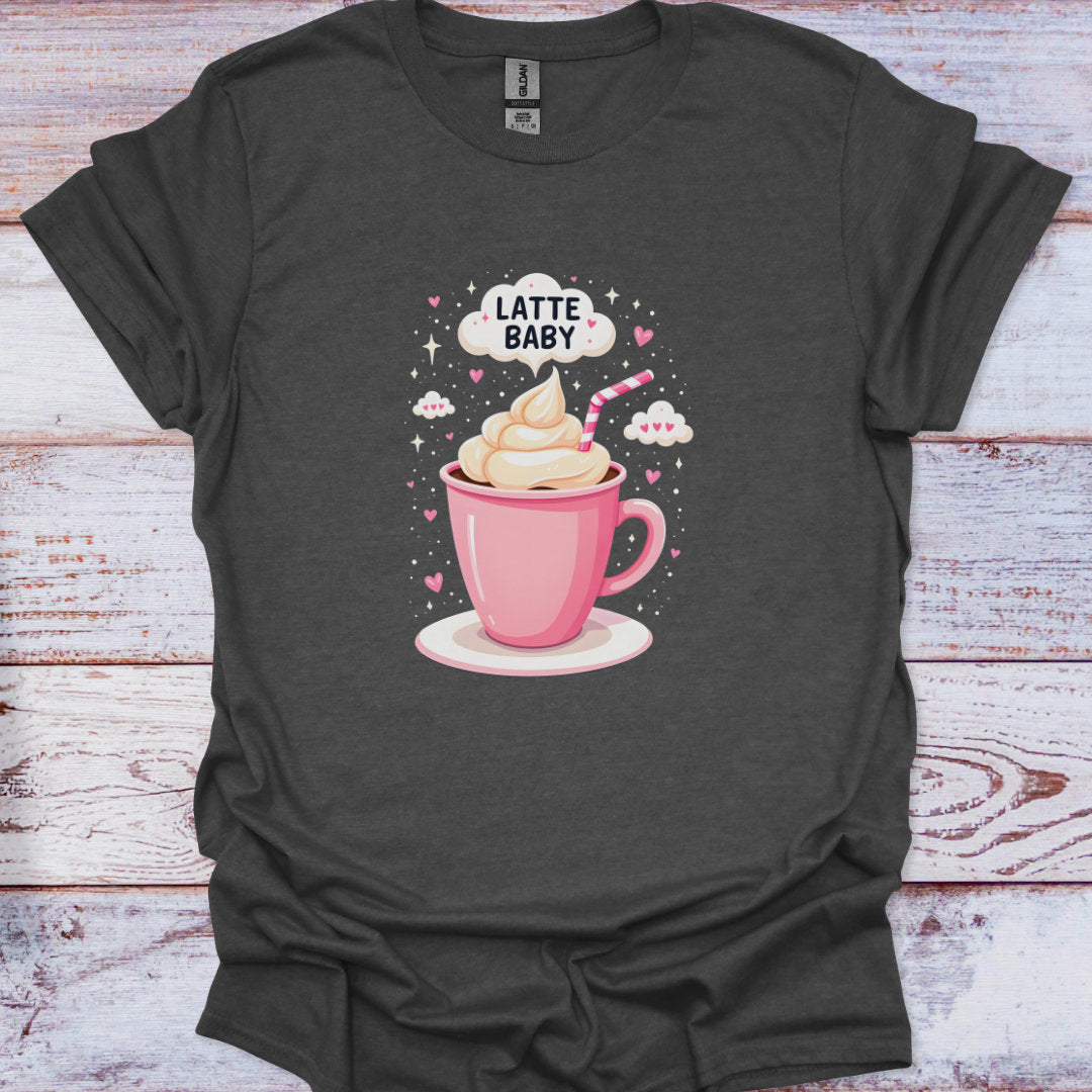 Dark gray t-shirt with a graphic of a pink coffee cup with whipped cream and a straw, labeled 'Latte Baby', on a wooden surface.