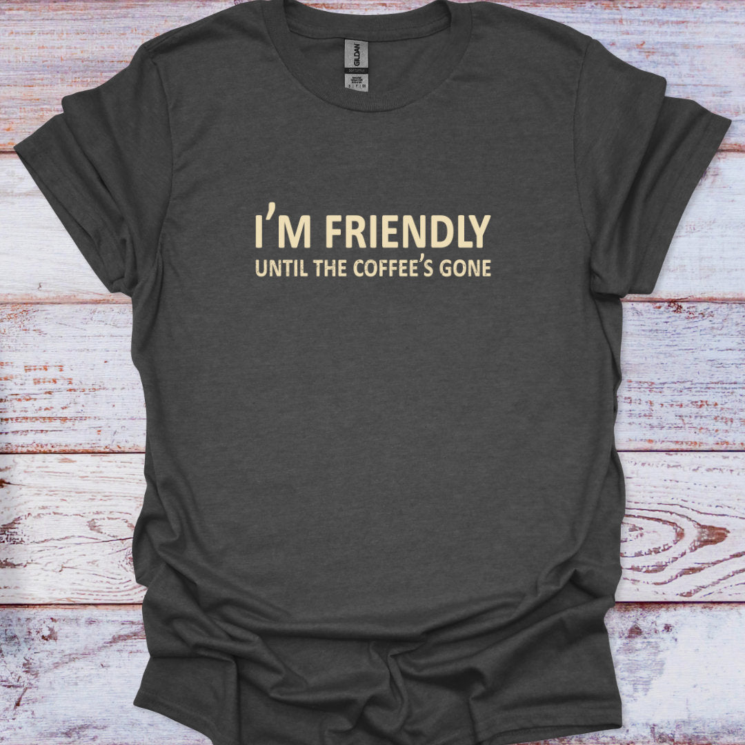 Dark gray t-shirt with 'I'm Friendly Until the Coffee's Gone' text on a wooden surface