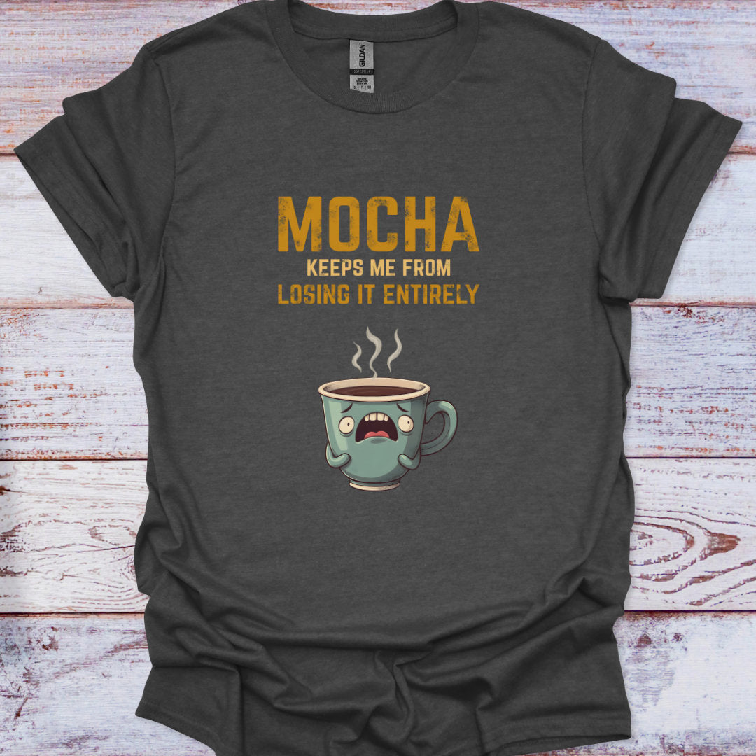Dark gray t-shirt with a cartoon coffee cup and text on a wooden surface