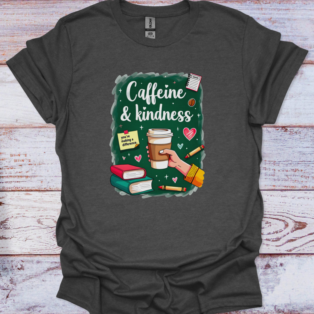 Dark gray t-shirt with a graphic design of a hand holding a coffee cup, books, and text 'Caffeine & kindness' on a wooden surface.