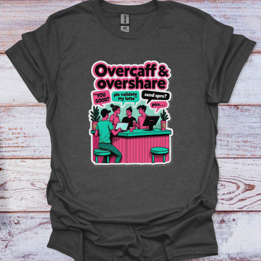 Gray t-shirt with a graphic design of people at a bar and text 'Overcaff & overshare' on a wooden surface.