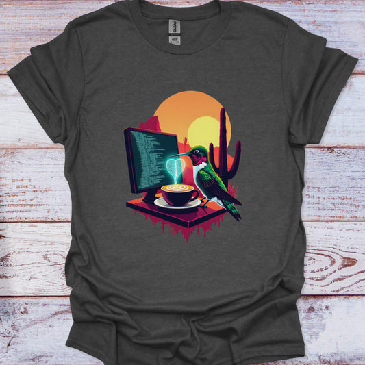 Dark gray t-shirt with a colorful graphic of a bird, computer, and coffee cup on a wooden surface.