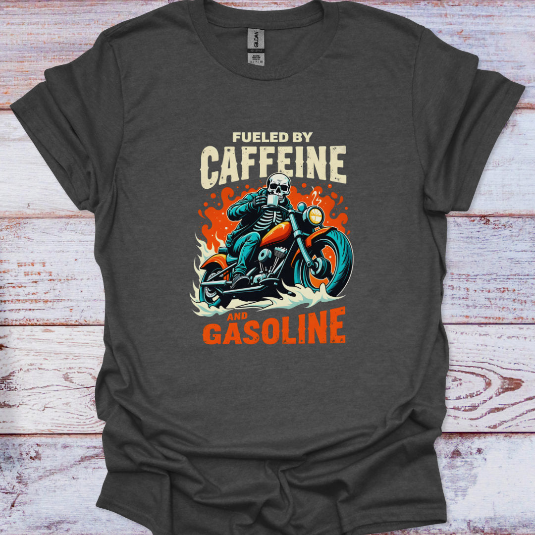 Dark gray t-shirt with a skeleton riding a motorcycle graphic and text 'Fueled by Caffeine and Gasoline' on a wooden surface.