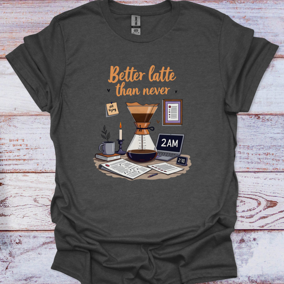 Dark gray t-shirt with coffee-themed graphic and 'Better latte than never' text on a wooden surface.