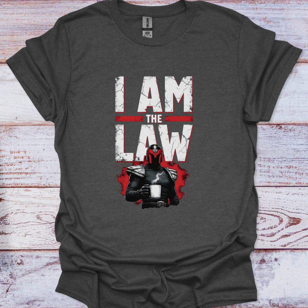 Gray t-shirt with 'I AM THE LAW' text and character graphic on a wooden surface