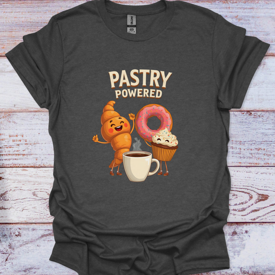 Dark gray t-shirt with cartoon characters and 'Pastry Powered' text on a wooden surface