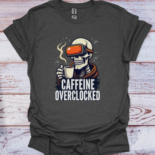 Gray t-shirt with a skeleton wearing VR goggles and holding a coffee cup, labeled 'Caffeine Overclocked', on a wooden surface.