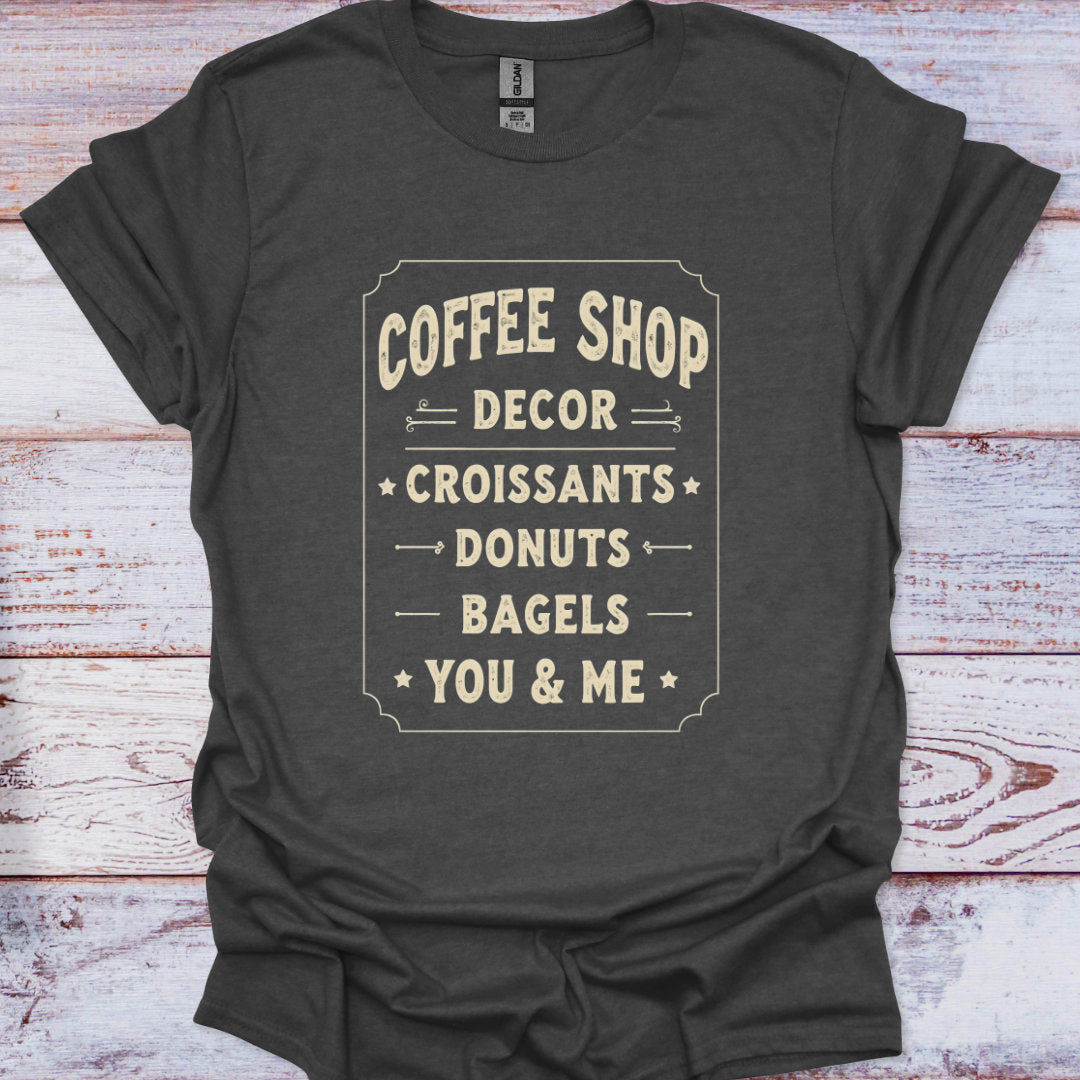 Dark gray t-shirt with white text on a wooden surface