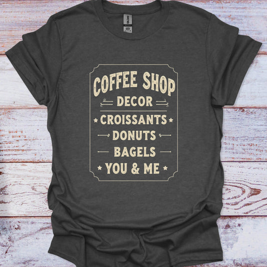Dark gray t-shirt with white text on a wooden surface
