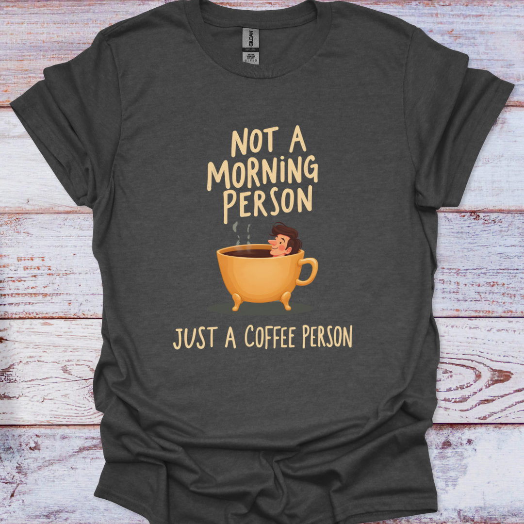 Dark gray t-shirt with a coffee cup graphic and text on a wooden surface