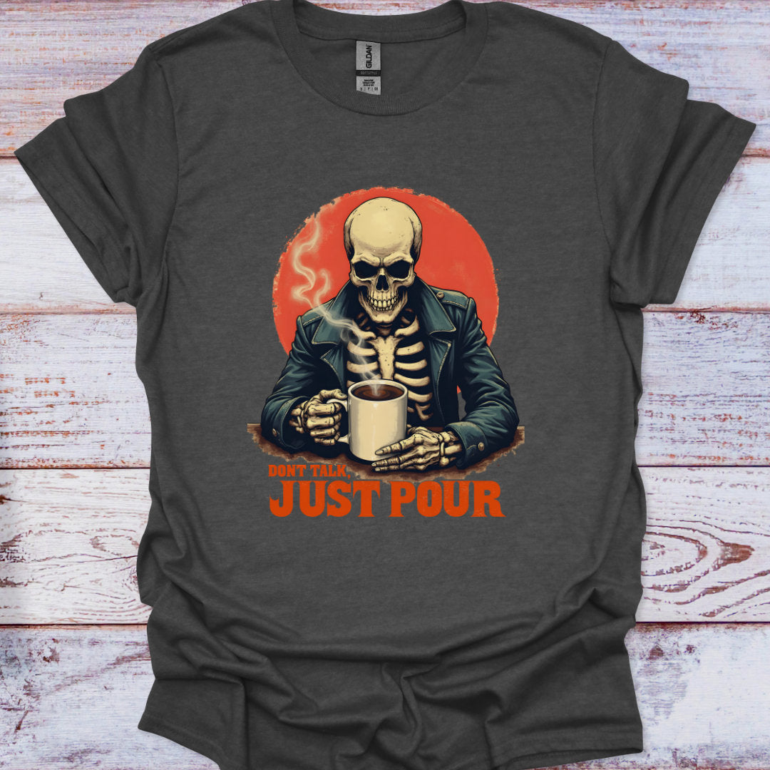 Dark gray t-shirt with a skeleton holding a coffee cup and 'Just Pour' text on a wooden surface.