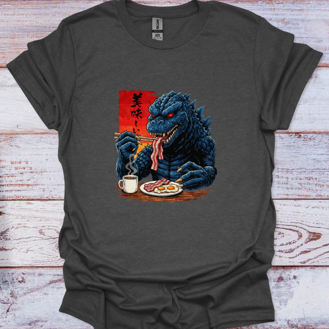 Gray t-shirt with a graphic of a blue kaiju eating breakfast on a wooden surface