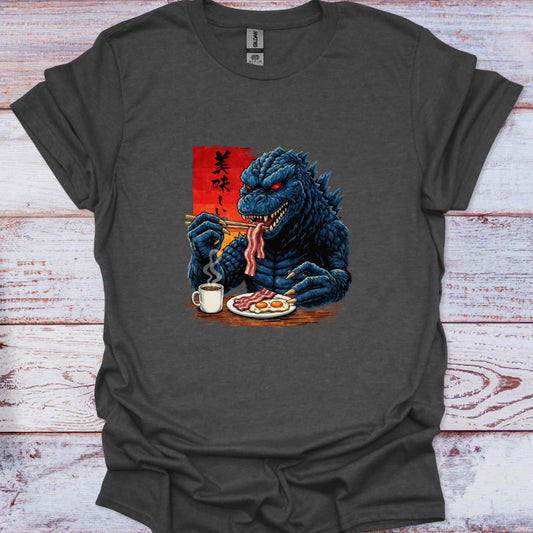 Gray t-shirt with a graphic of a blue kaiju eating breakfast on a wooden surface