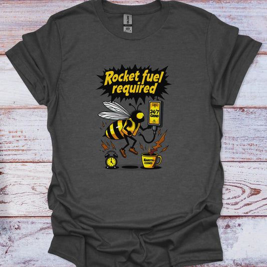 Gray t-shirt with a bee graphic and 'Rocket fuel required' text on a wooden surface