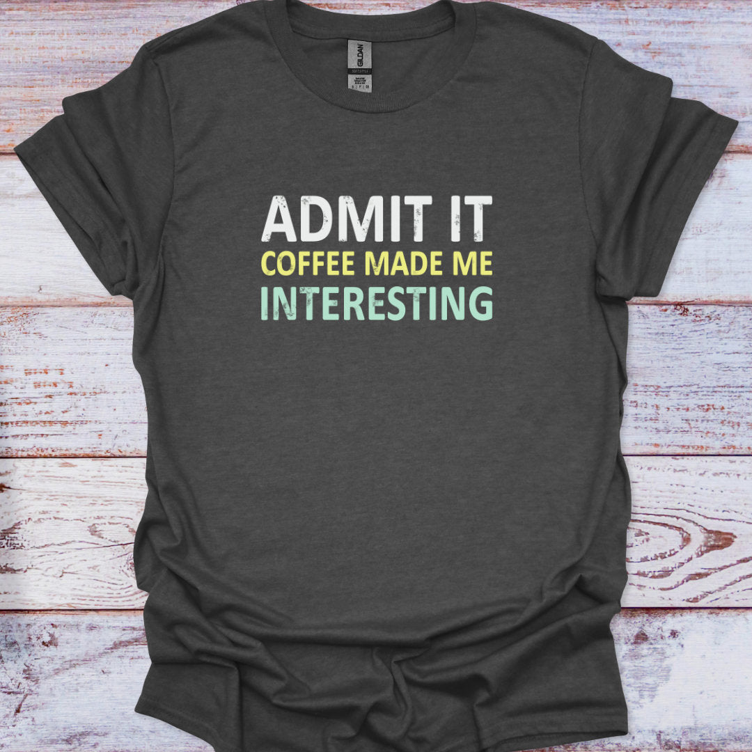 Dark gray t-shirt with 'Admit It Coffee Made Me Interesting' text on a wooden surface