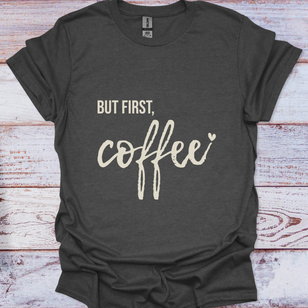 Dark gray t-shirt with 'But first, coffee' text on a wooden surface