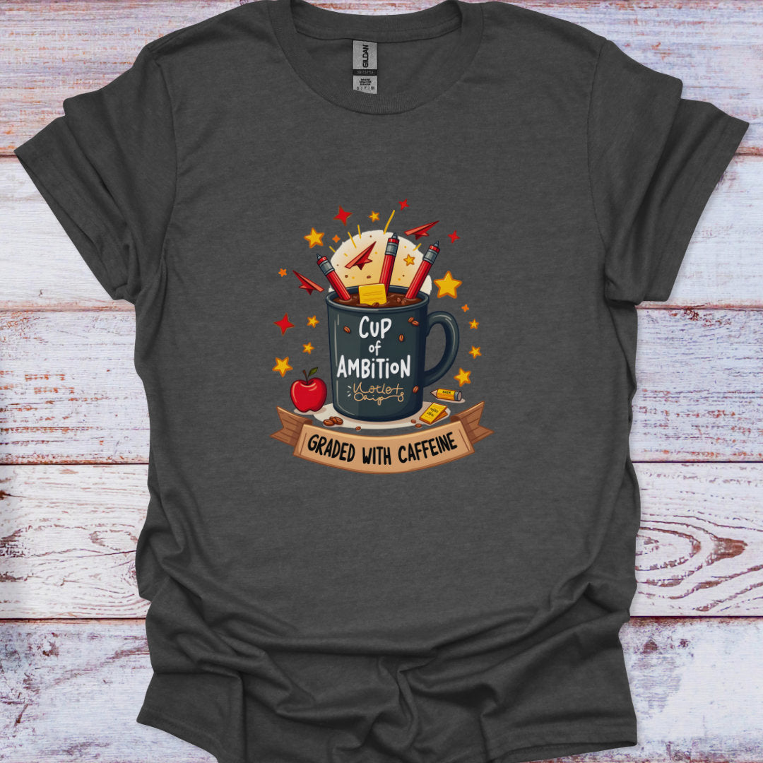 Dark gray t-shirt with a graphic design of a mug labeled 'Cup of Ambition' on a wooden surface.