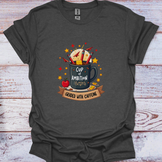Dark gray t-shirt with a graphic design of a mug labeled 'Cup of Ambition' on a wooden surface.