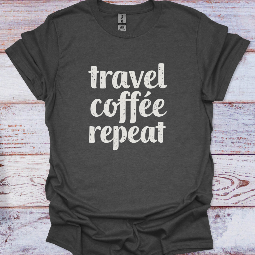 Dark gray t-shirt with 'travel coffee repeat' text on a wooden surface