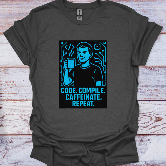 Gray t-shirt with blue graphic and text 'Code. Compile. Caffeinate. Repeat.' on a wooden surface.
