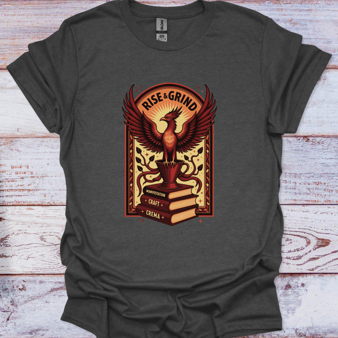 Dark gray t-shirt with a phoenix graphic and 'Rise & Grind' text on a wooden surface