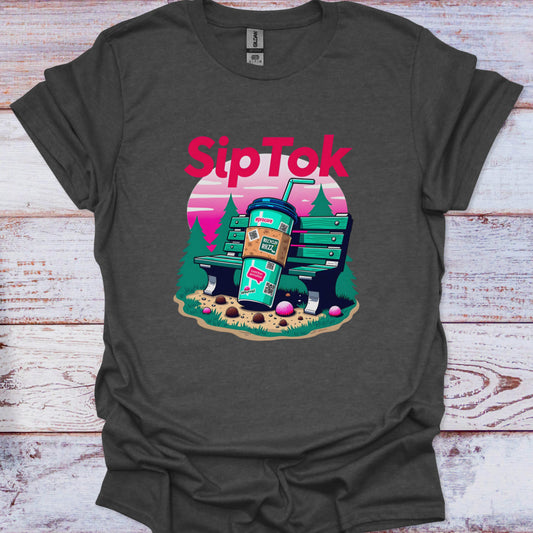Dark gray t-shirt with 'Sip Tok' graphic design featuring a coffee cup and park bench on a wooden surface.