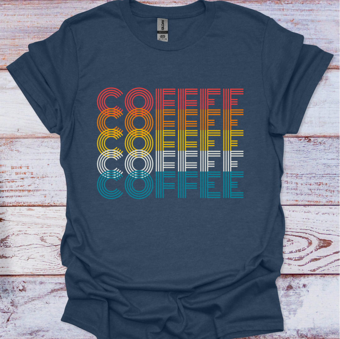 Navy blue t-shirt with 'COFFEE' graphic in multicolor on a wooden surface