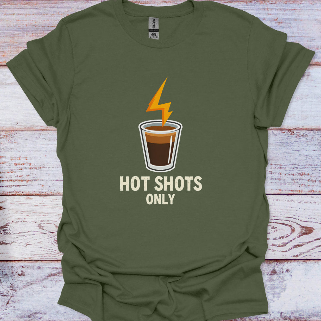 Green t-shirt with a coffee cup graphic and 'Hot Shots Only' text on a wooden surface