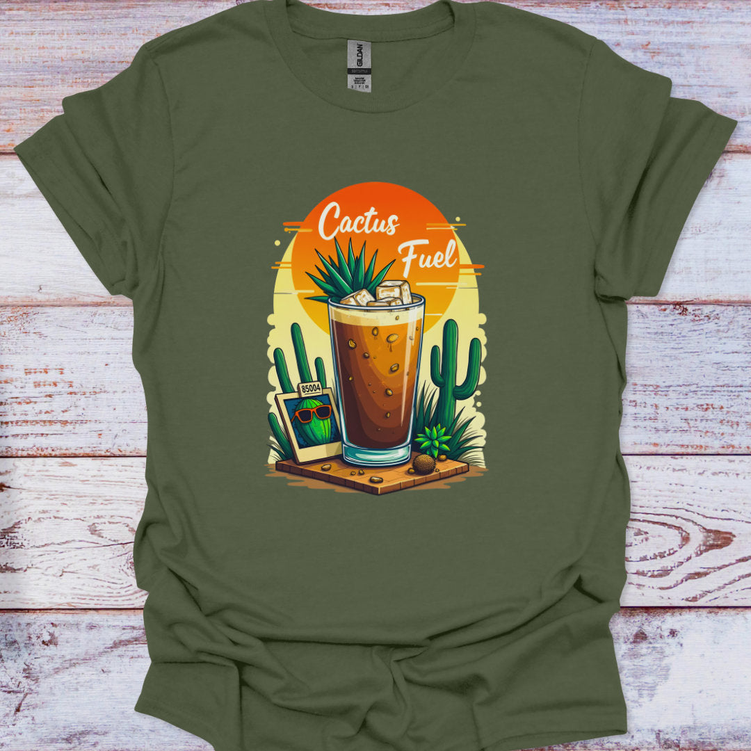 Green t-shirt with a graphic of a glass of iced coffee with cactus plants and 'Cactus Fuel' text on a wooden surface.