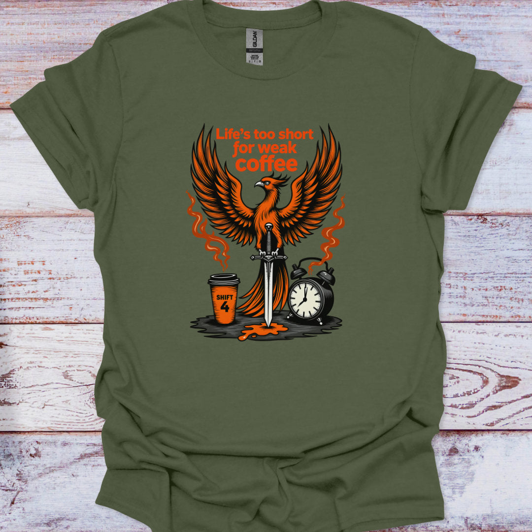 Green t-shirt with a graphic design featuring a phoenix, coffee cup, and alarm clock on a wooden surface.