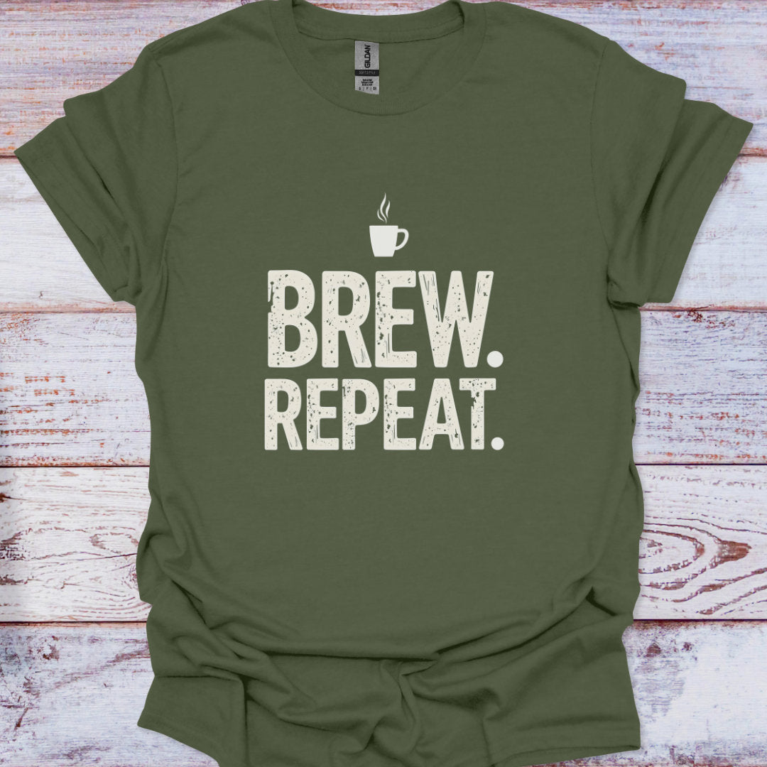 Green t-shirt with 'Brew. Repeat.' text and coffee cup graphic on a wooden surface