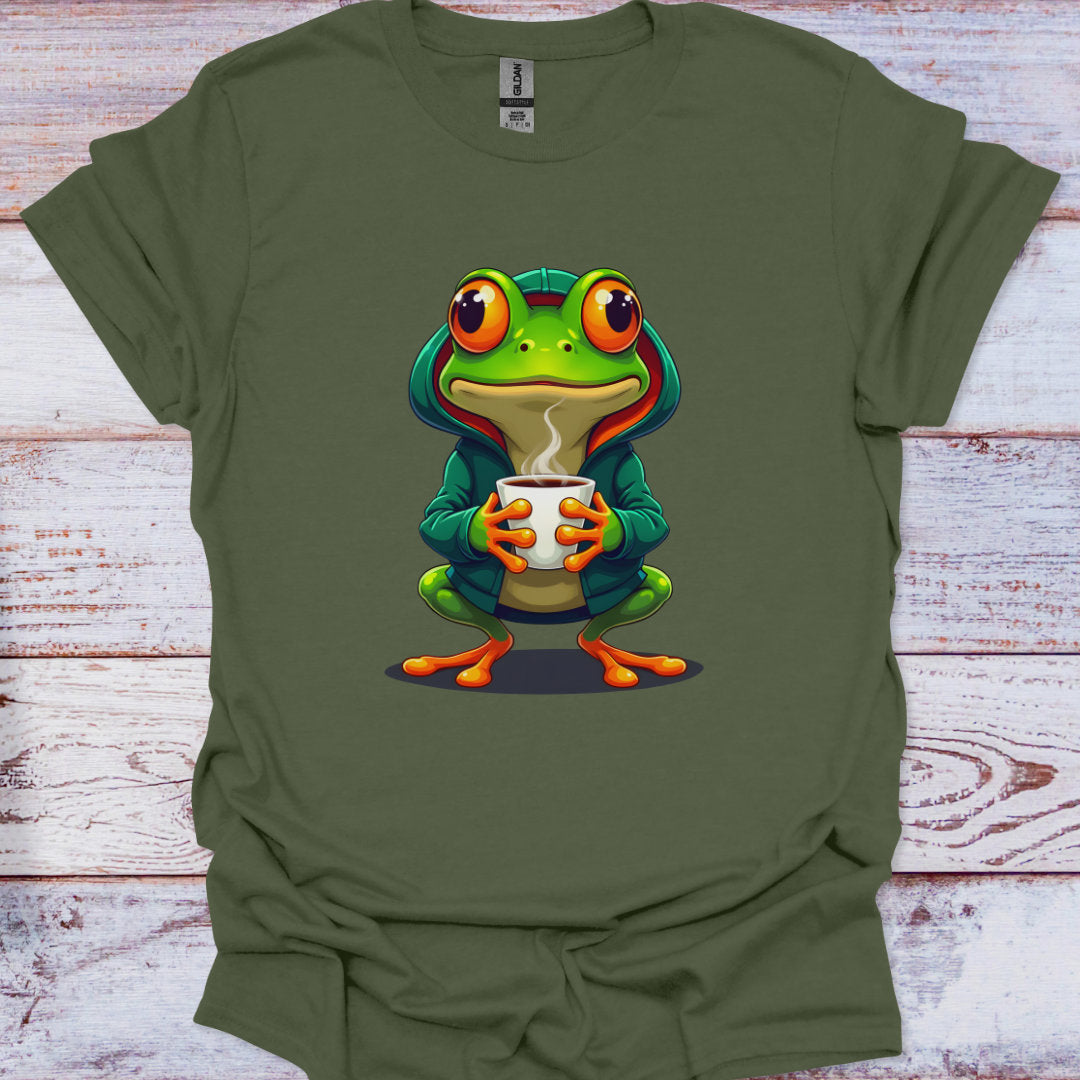 Green t-shirt with a cartoon frog holding a cup on a wooden surface