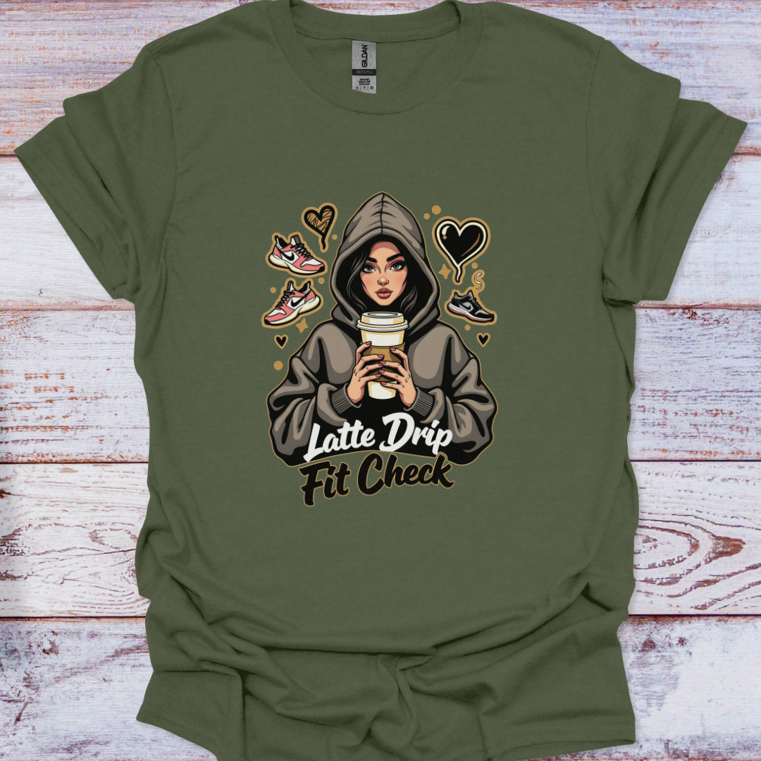 Green t-shirt with a graphic of a person in a hoodie holding a coffee cup, text 'Latte Drip Fit Check', and shoe icons on a wooden surface.