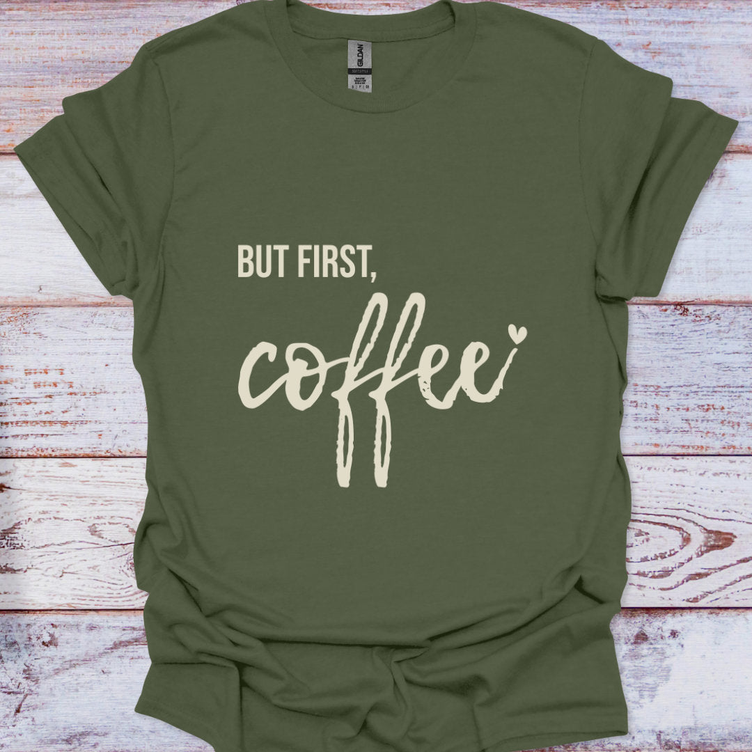 Green t-shirt with 'But first, coffee' text on a wooden surface