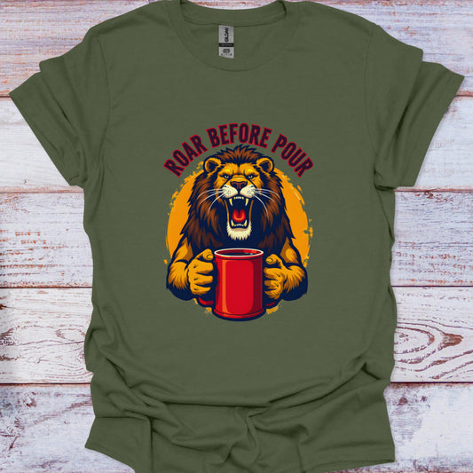 Green t-shirt with a graphic of a lion holding a red cup and text 'Roar Before Pour' on a wooden surface.