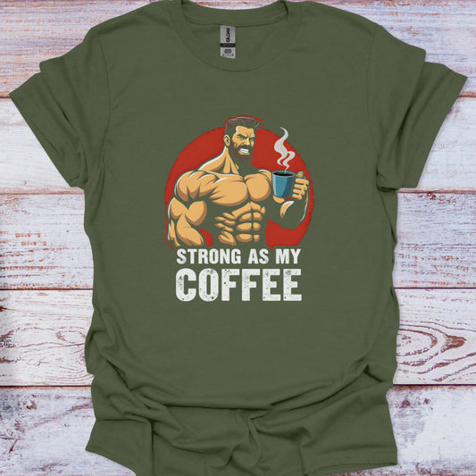 Green t-shirt with a graphic of a muscular man holding a coffee cup and text 'Strong as my coffee' on a wooden surface.