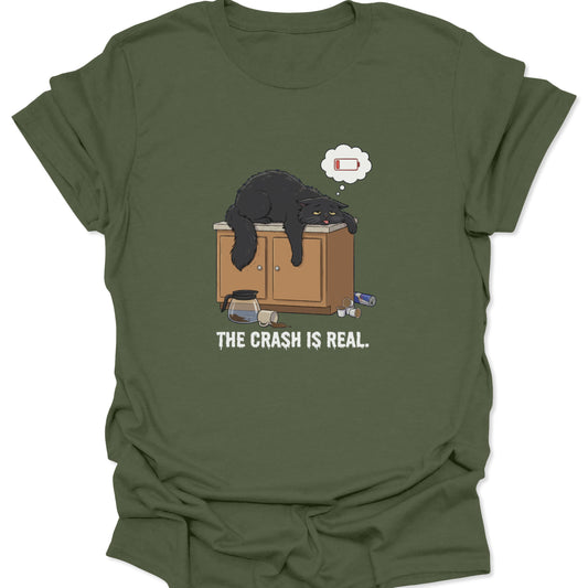 Graphic tee on military green fabric showing a tired black cat slumped over a counter with a low battery thought bubble.