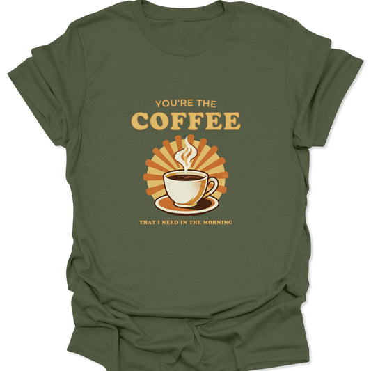 Military green t-shirt with a central graphic of a steaming coffee cup and sunburst, featuring bold cream-colored retro text.