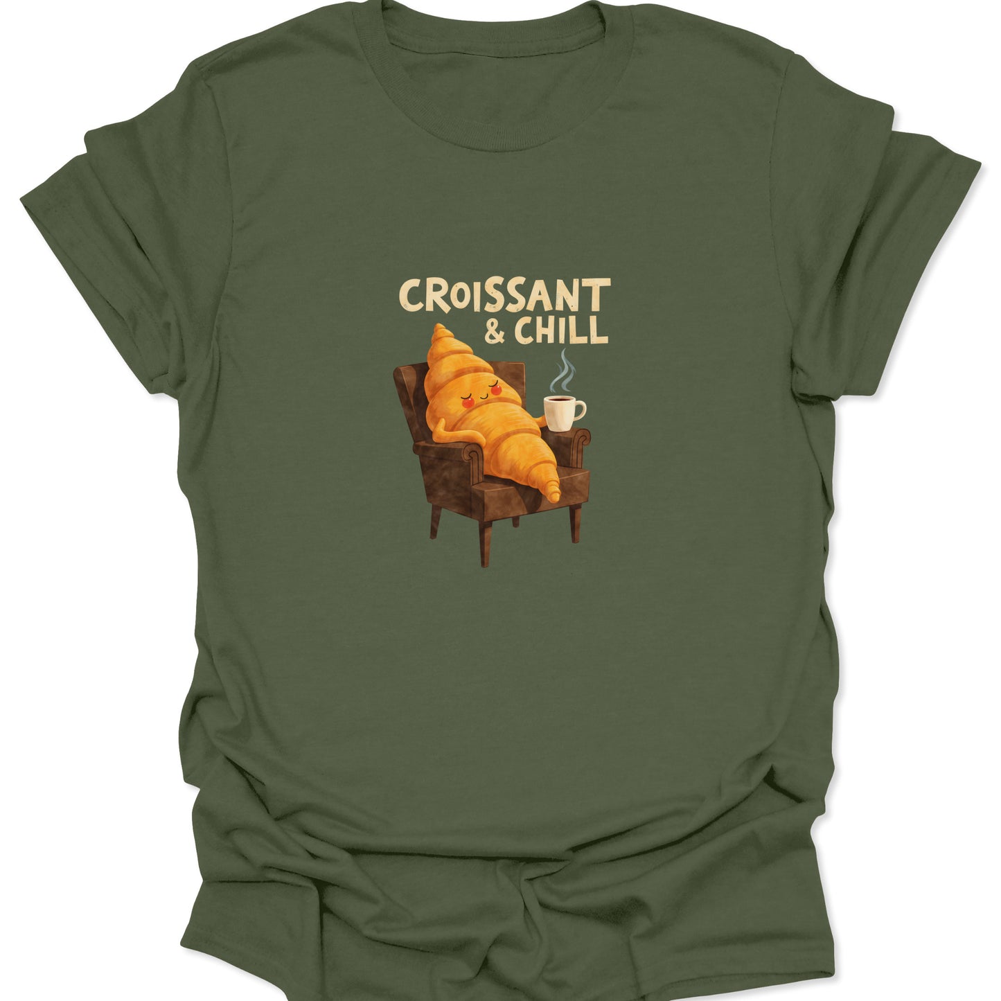 Cozy vibe graphic t-shirt showing a smiling croissant relaxing in a chair with a cup of coffee, text above the image, shirt is military green.
