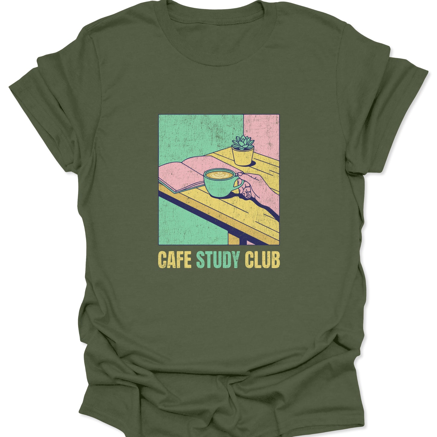 Distressed retro graphic on a military green shirt with a block print illustration of a cafe table, book, and coffee mug in muted pink and green tones.