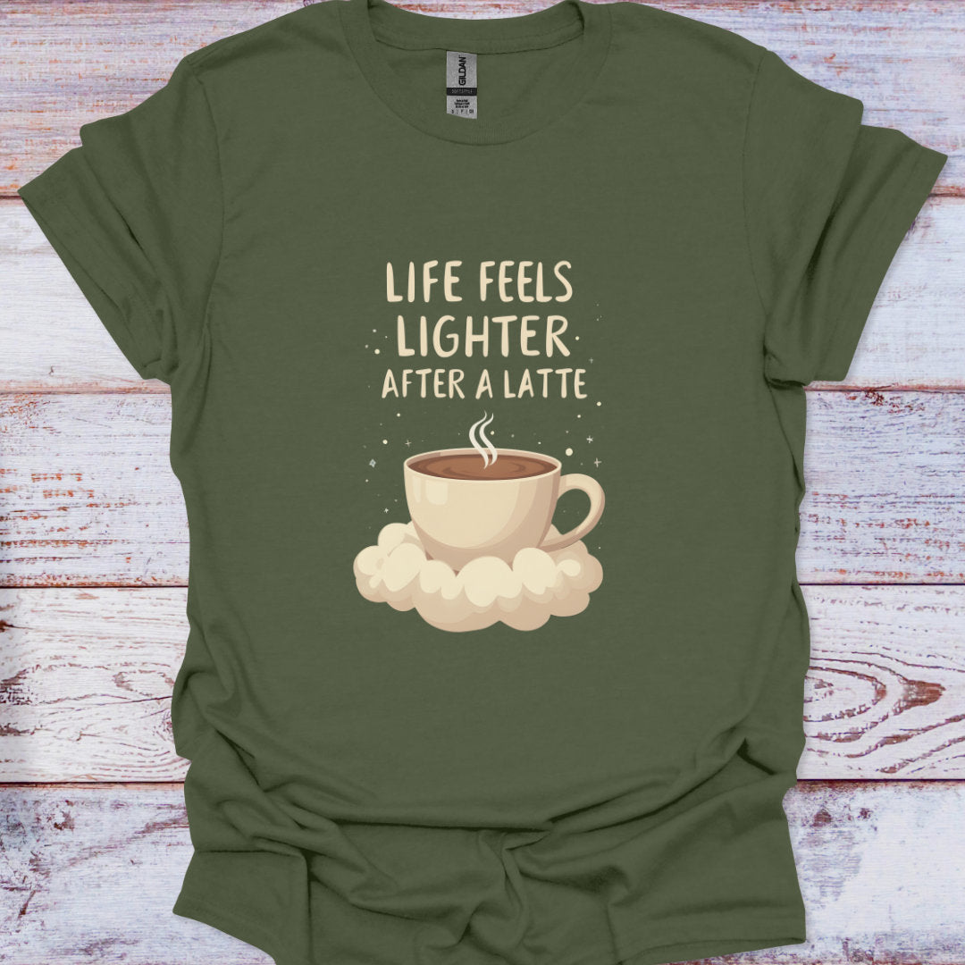 Green t-shirt with a coffee cup graphic and text 'Life feels lighter after a latte' on a wooden surface.
