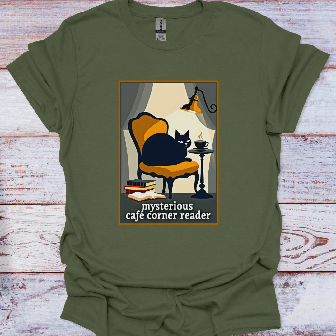 Green t-shirt with a graphic of a cat in a cafe and text 'mysterious cafe corner reader' on a wooden surface.