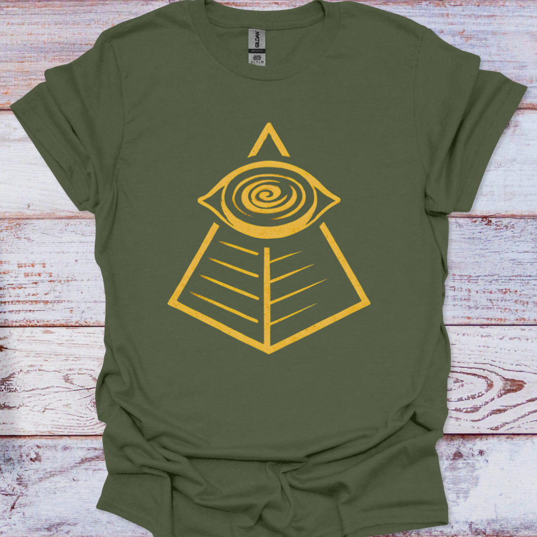 Green t-shirt with yellow pyramid and eye design on a wooden surface