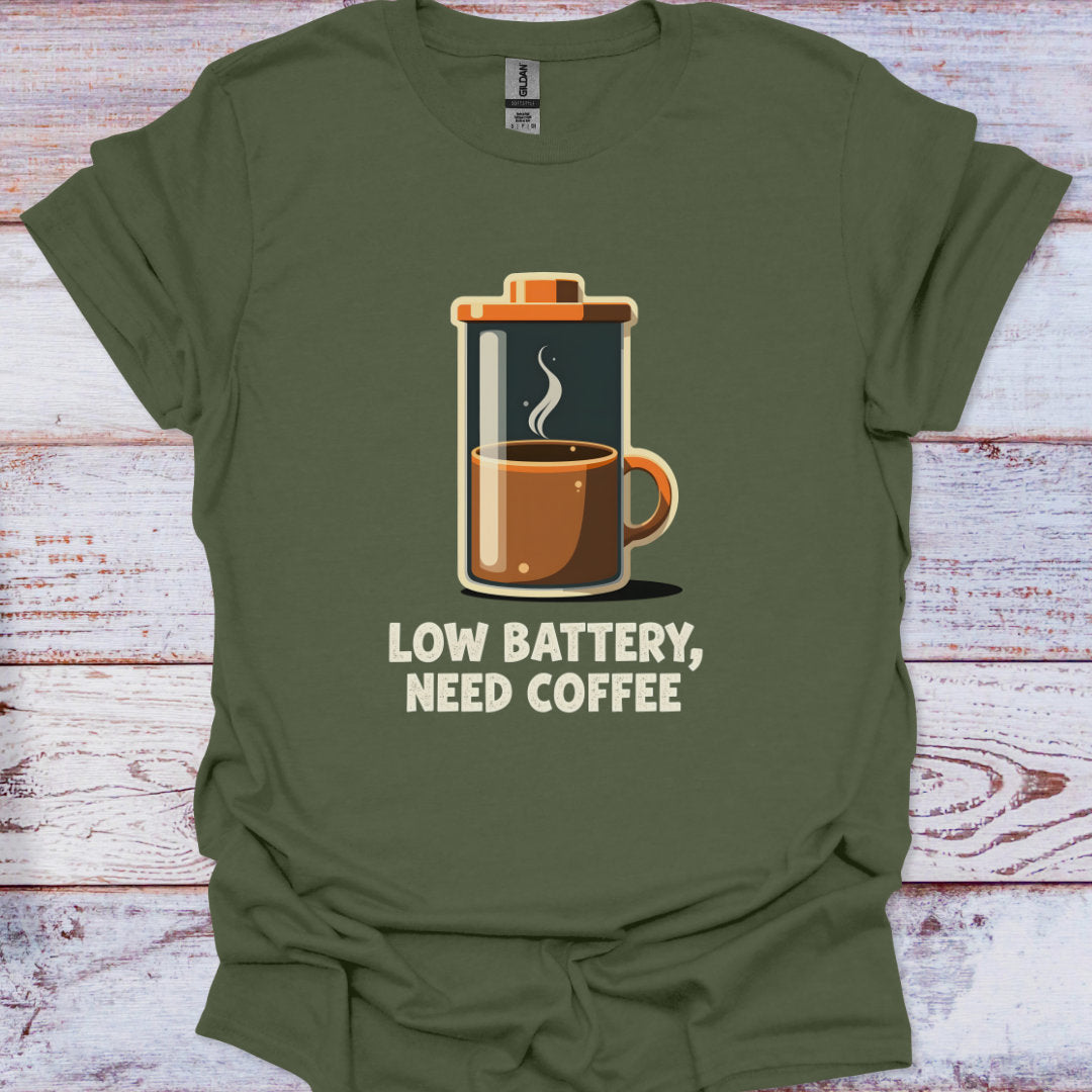 Green t-shirt with a coffee-themed graphic and text 'Low battery, need coffee' on a wooden surface.