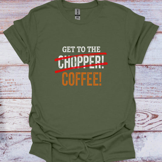 Green t-shirt with humorous text design on a wooden surface