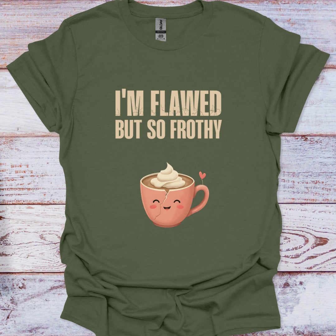 Green t-shirt with a coffee cup graphic and text 'I'm Flawed But So Frothy' on a wooden surface.