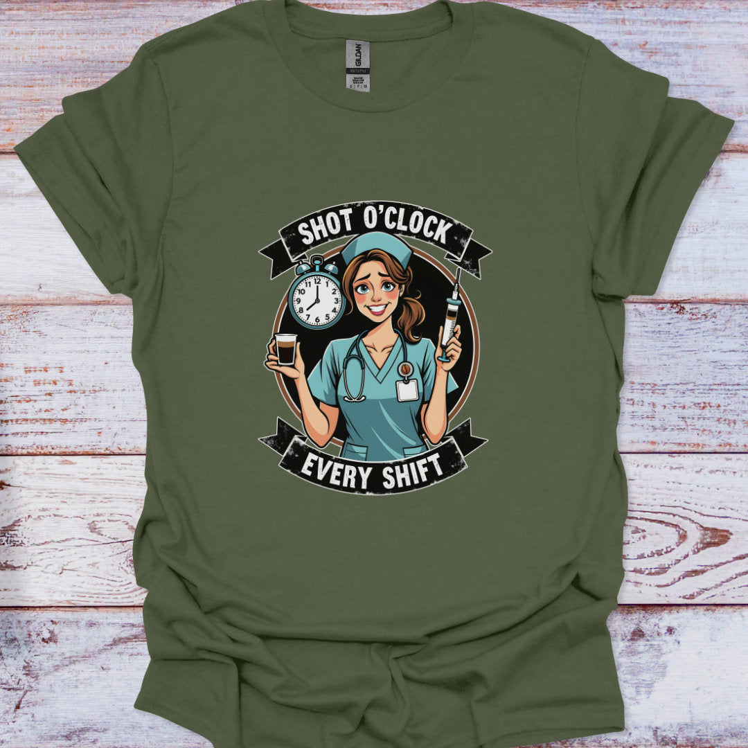 Green t-shirt with a graphic of a nurse and text 'Shot O'Clock Every Shift' on a wooden surface.