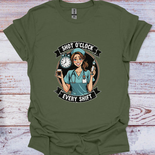 Green t-shirt with a graphic of a nurse and text 'Shot O'Clock Every Shift' on a wooden surface.