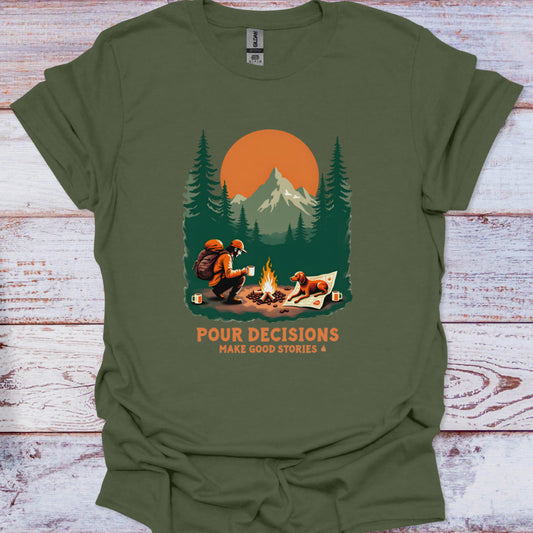 Green t-shirt with a graphic of a man and his dog by a campfire and mountains, with text 'Pour Decisions Make Good Stories &'.